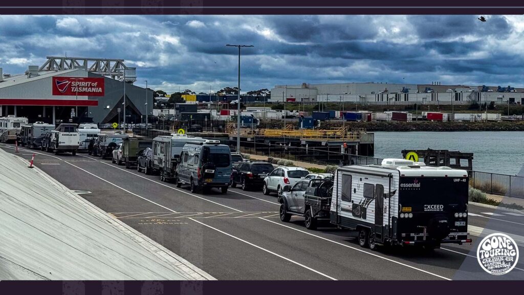 Caravan with Do Not Overtake Turning Vehicle sign approaching Spirit of Tasmania ferry terminal